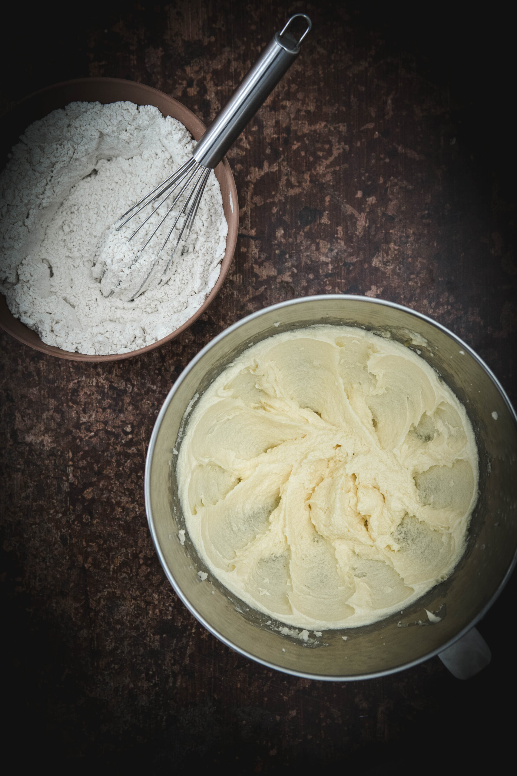 creamed butter and sugar next to a bowl of dry ingredients
