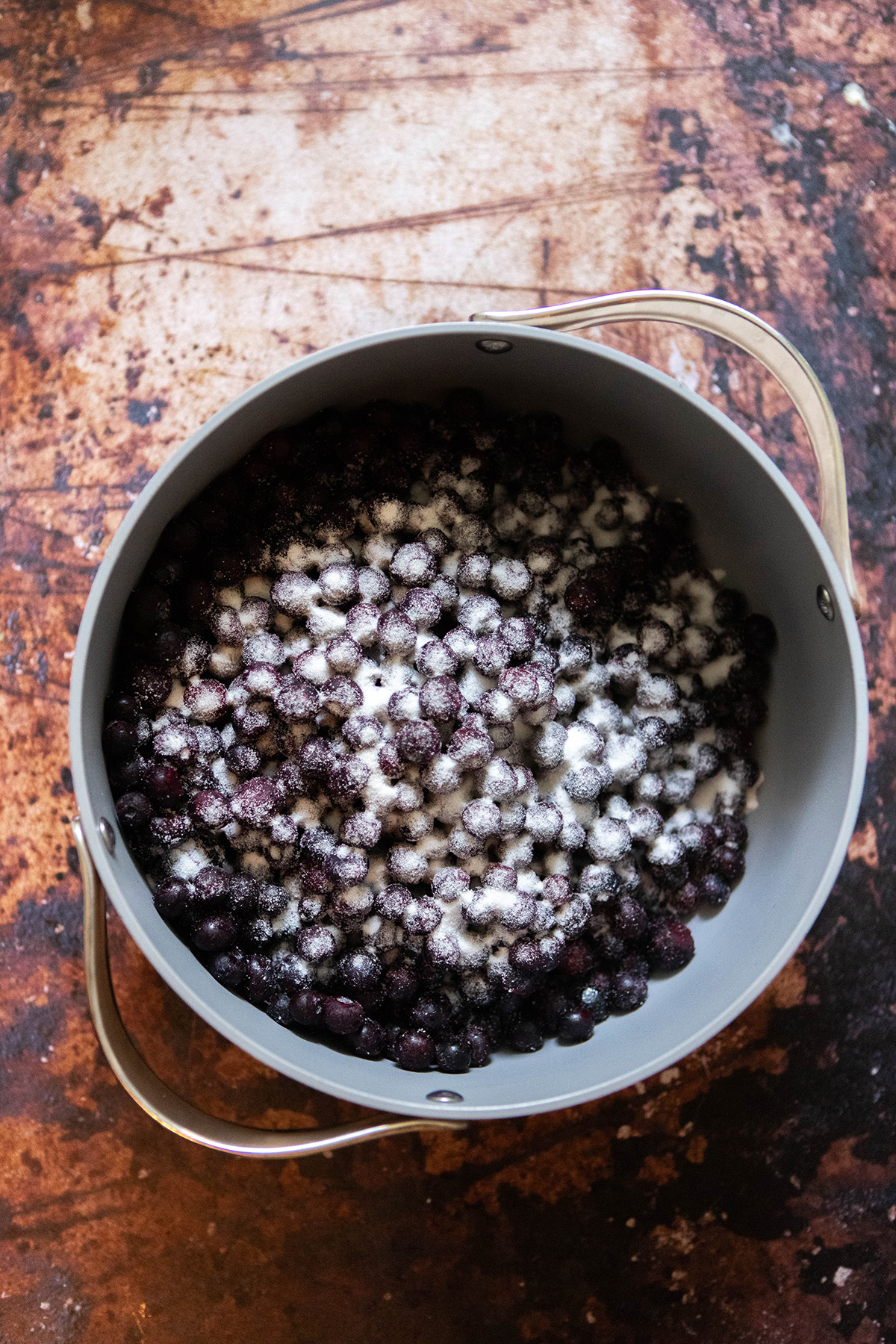 blueberries in a pot with sugar on top