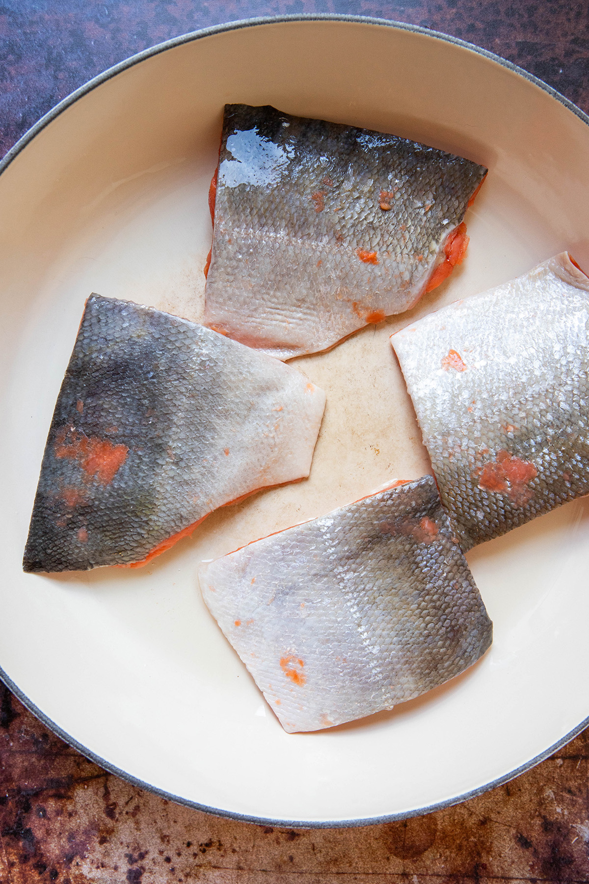 Salmon filets skin up in a pan