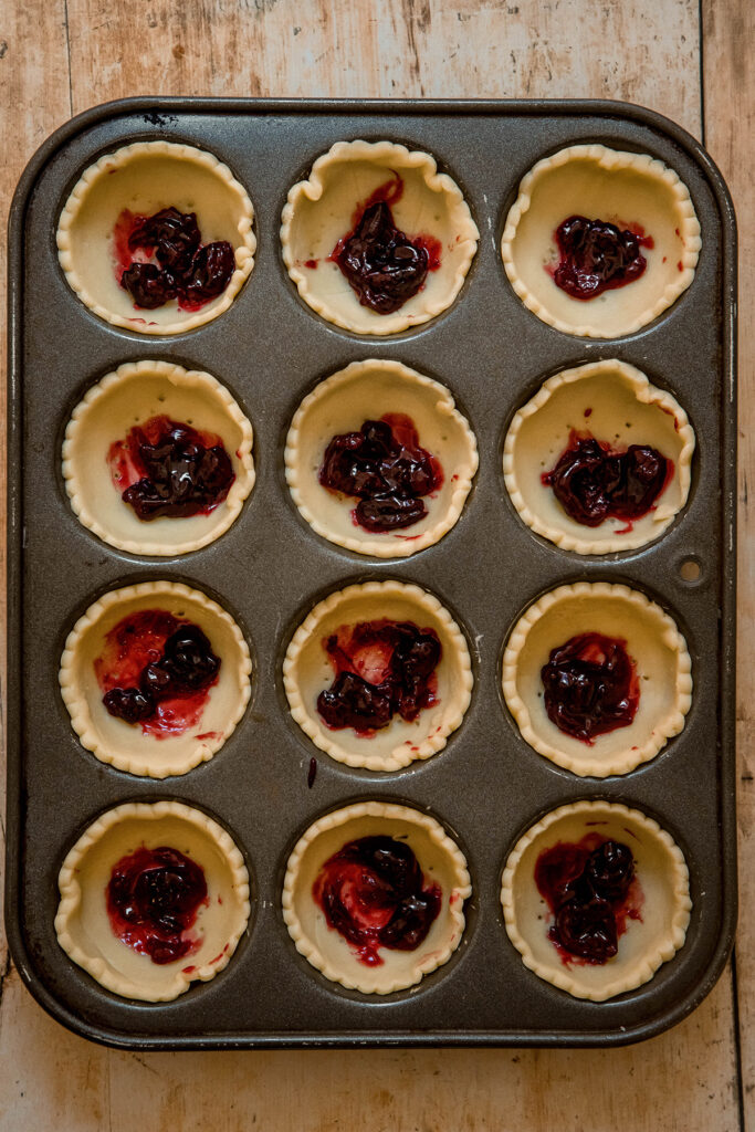 tartlets with jam in the bottom for cherry bakewell tarts