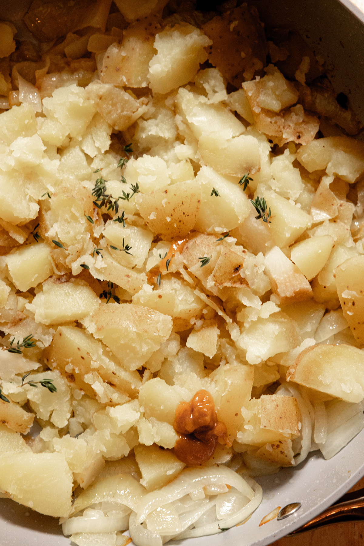 potatoes onions and spices in a pan