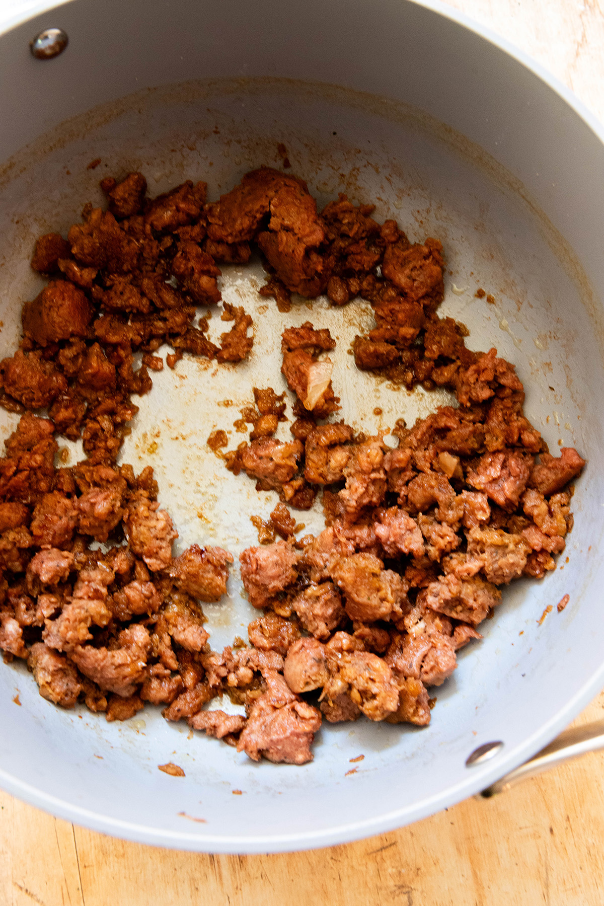 broken down cooked sausage in a pot