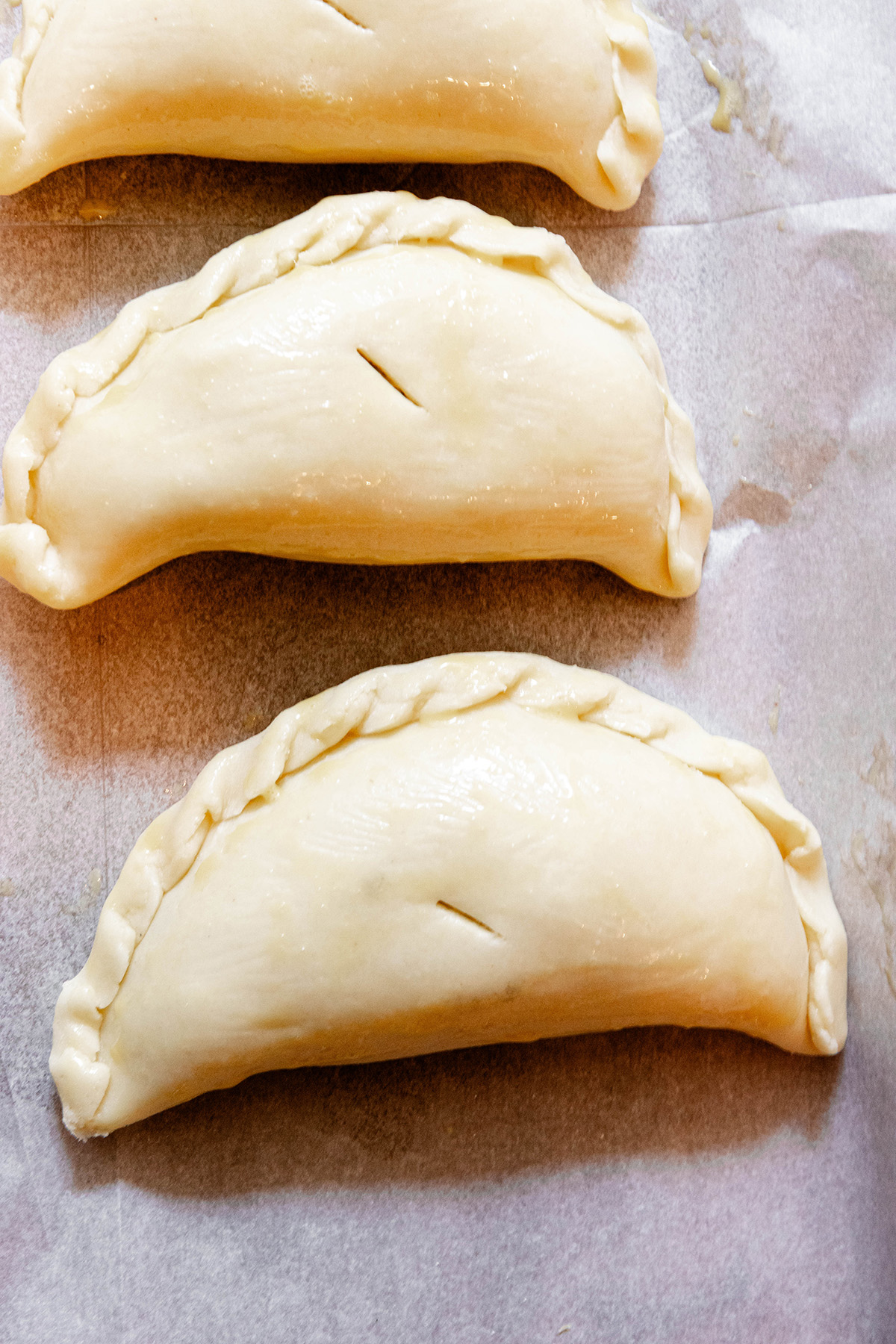 Cheese and Onion Pasty Recipe: Vegetarian Pasties sitting on a baking sheet