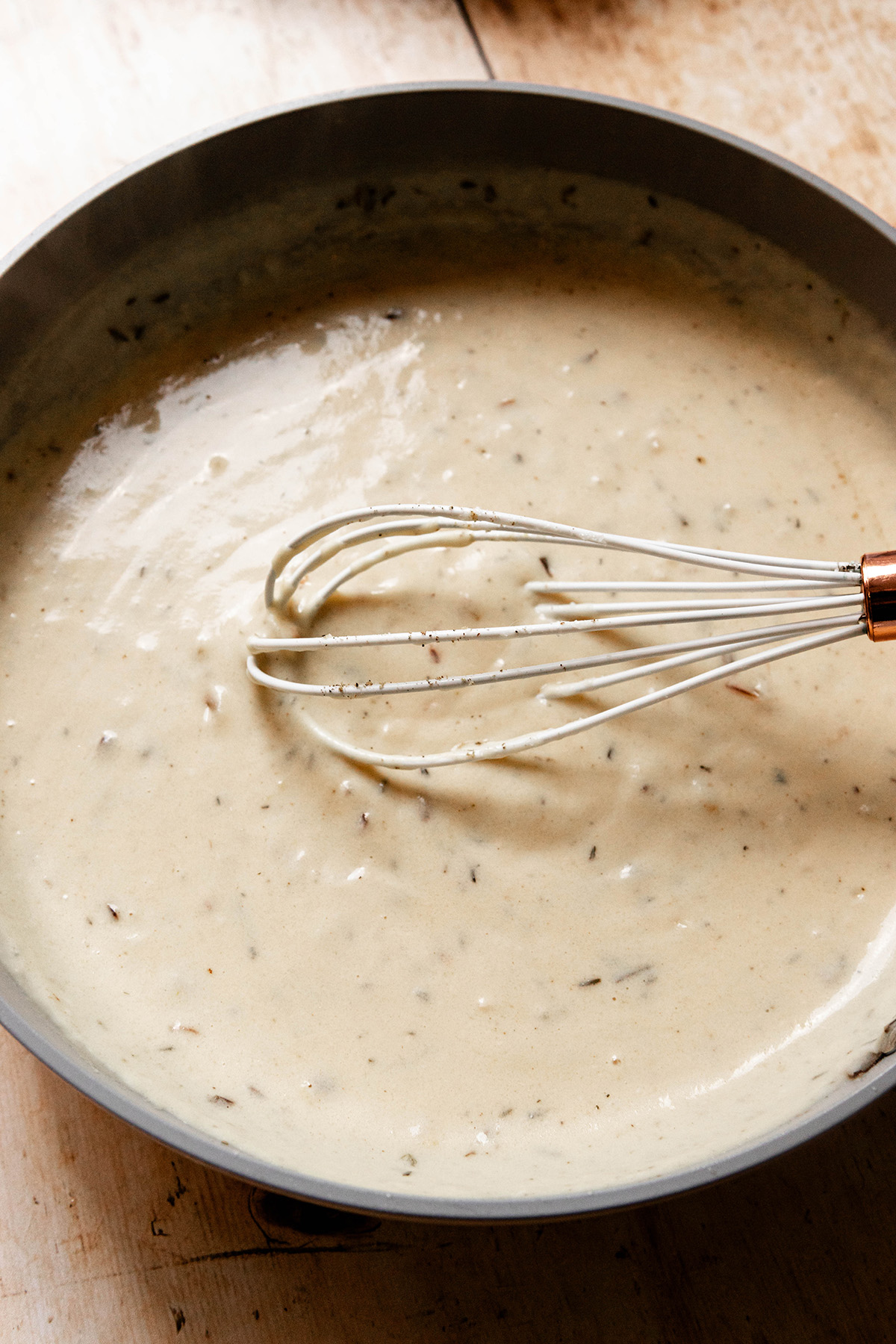 sauce in a pan with a whisk