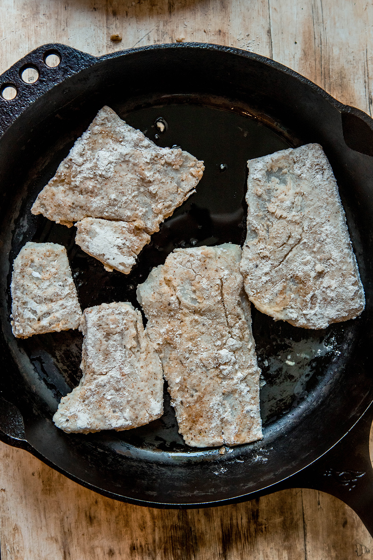 fried fish in a cast iron pan