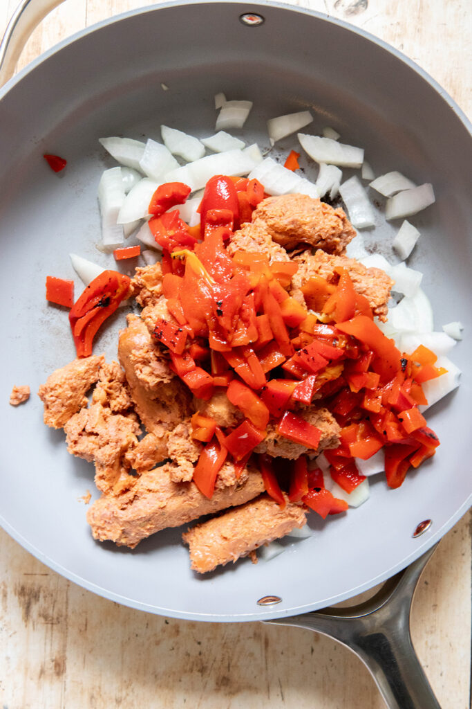 sausage, red pepper, and onions in a frying pan