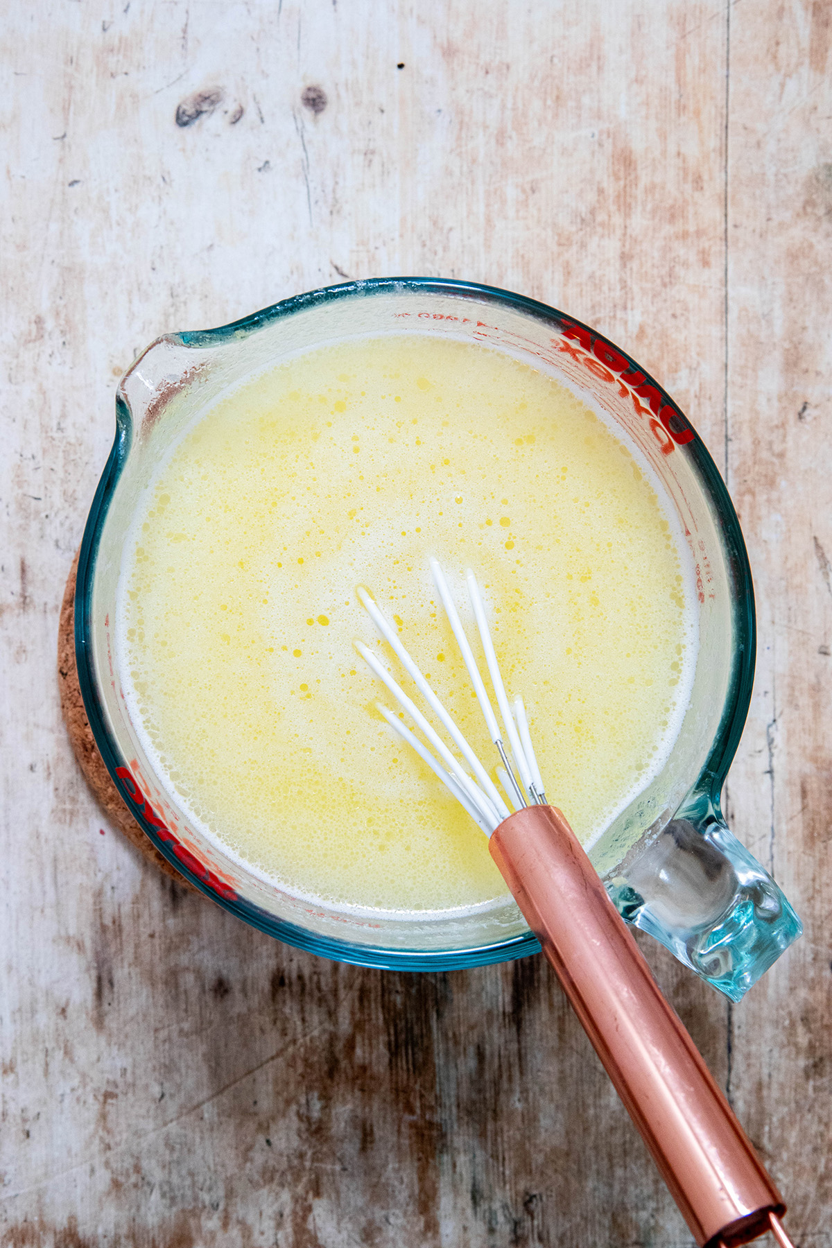 miso butter broth in a measuring cup